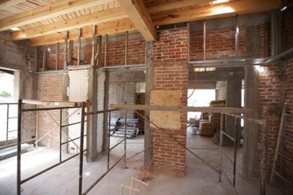 Dining/Kitchen area showing wood beams and ceilings, before plastering.